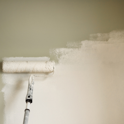 using roller to paint walls